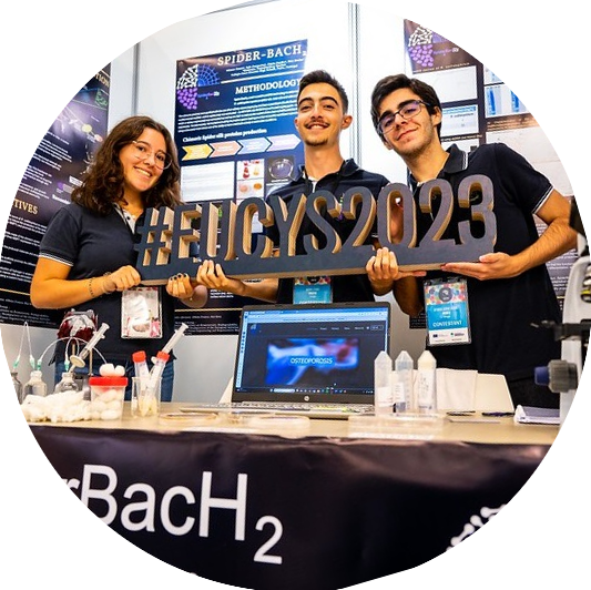 Three young people with a EUCYS2023 sign